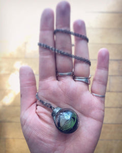 Glass Globe Necklace with Black and Green Feather